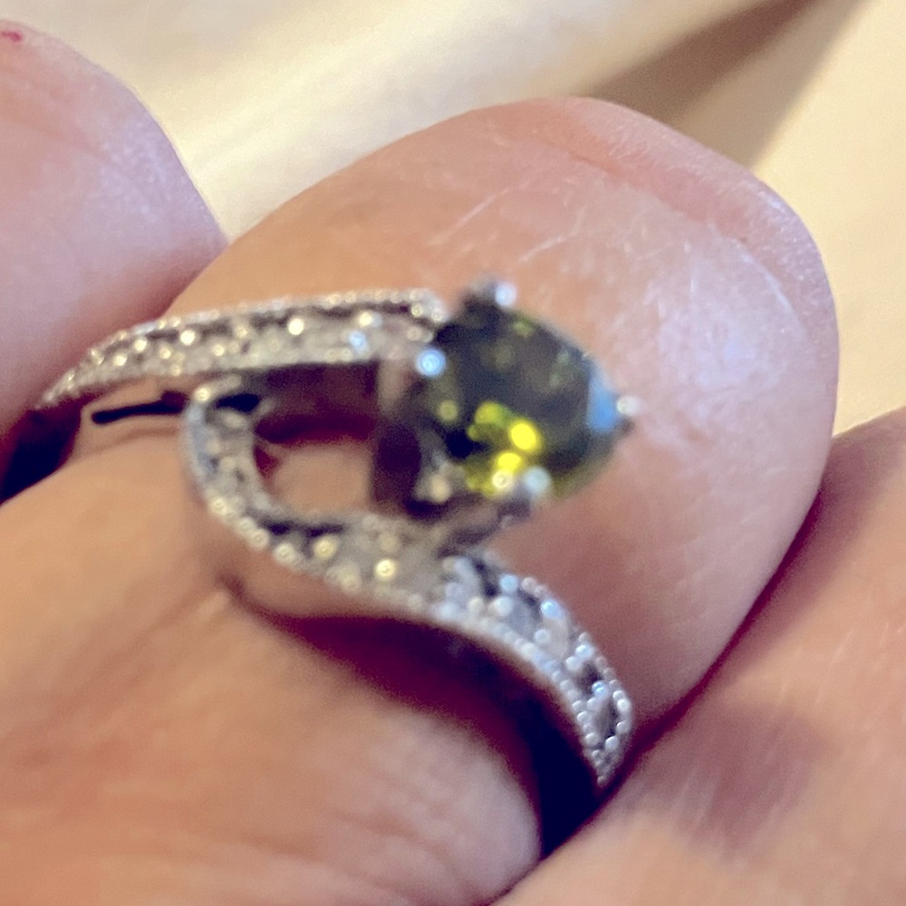 A size 8 silver ring with a stunning green cubic zirconia stone.